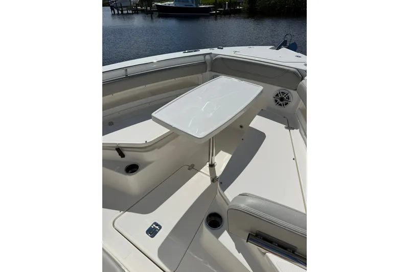 Slide: The Image of 2023 Pursuit S 248 Sport boat interior with seating and table setup. - 30