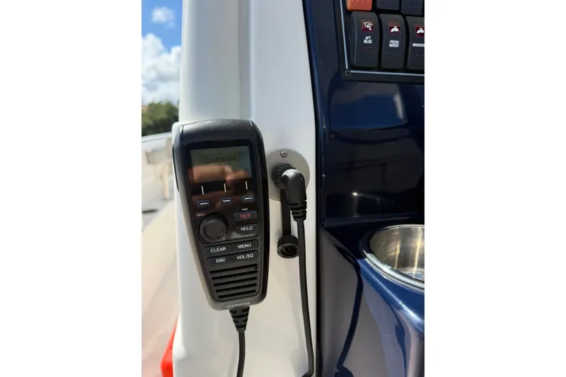 Slide: The Image of 2023 Pursuit S 248 Sport boat console with Garmin marine radio and control panel. - 18
