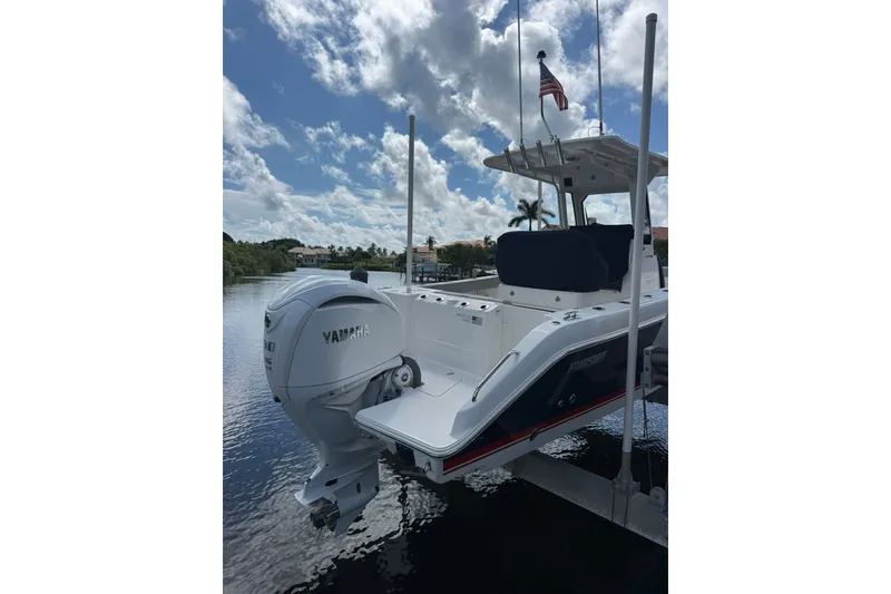 Slide: The Image of 2023 Pursuit S 248 Sport boat with Yamaha engine docked on a sunny day. - 1