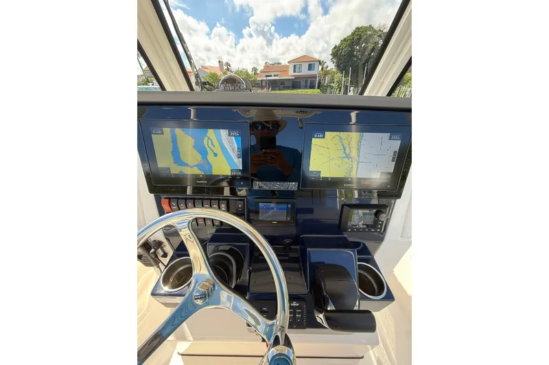 Slide: The Image of 2023 Pursuit S 248 Sport dashboard with navigation screens and steering wheel. - 15