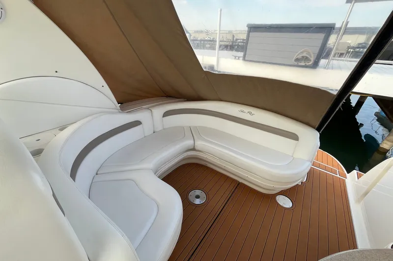 Slide: The Image of 2005 Sea Ray Sundancer 320 interior with white seating and teak flooring. - 17