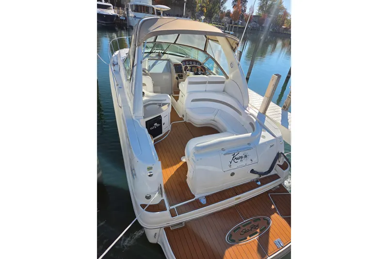 Slide: The Image of 2005 Sea Ray Sundancer 320 yacht docked, featuring spacious seating and elegant design. - 8
