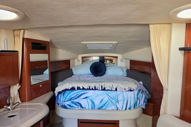 Slide: The Image of Luxurious cabin interior of 2005 Sea Ray Sundancer 320 with cozy bedding and elegant wood finishes. - 19