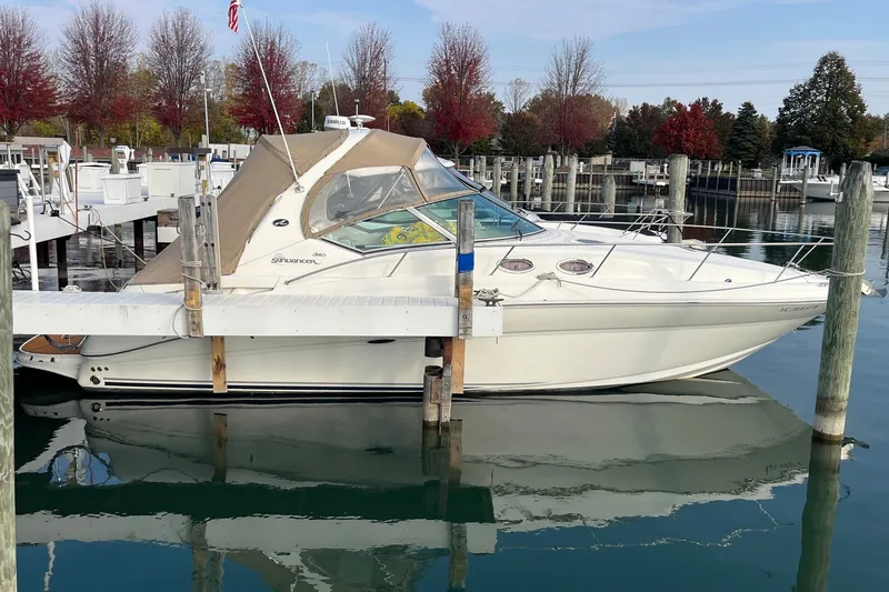 The Image of 2005 Sea Ray Sundancer 320 docked at marina with autumn trees in background. - 0