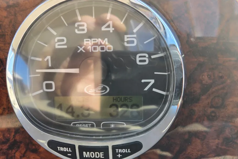 Slide: The Image of Close-up of a 2005 Sea Ray Sundancer 320 tachometer displaying RPM and engine hours. - 12