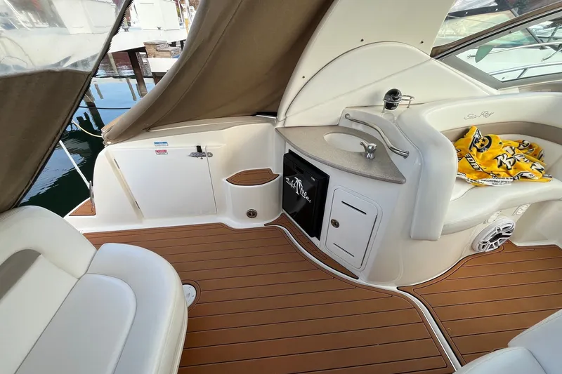 Slide: The Image of 2005 Sea Ray Sundancer 320 interior with seating, sink, and wooden flooring. - 16