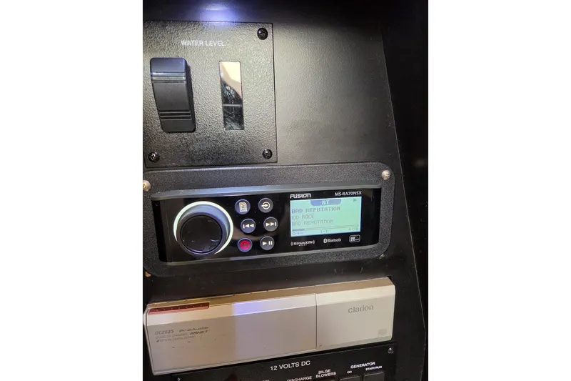 Slide: The Image of Control panel of a 2005 Sea Ray Sundancer 320 with audio system and water level indicator. - 28