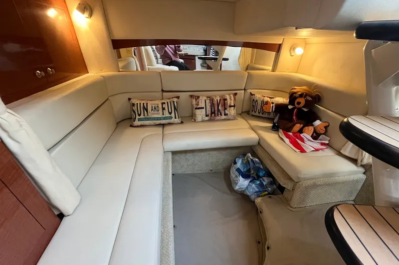 Slide: The Image of Interior of 2005 Sea Ray Sundancer 320 with cozy seating and decorative pillows. - 23