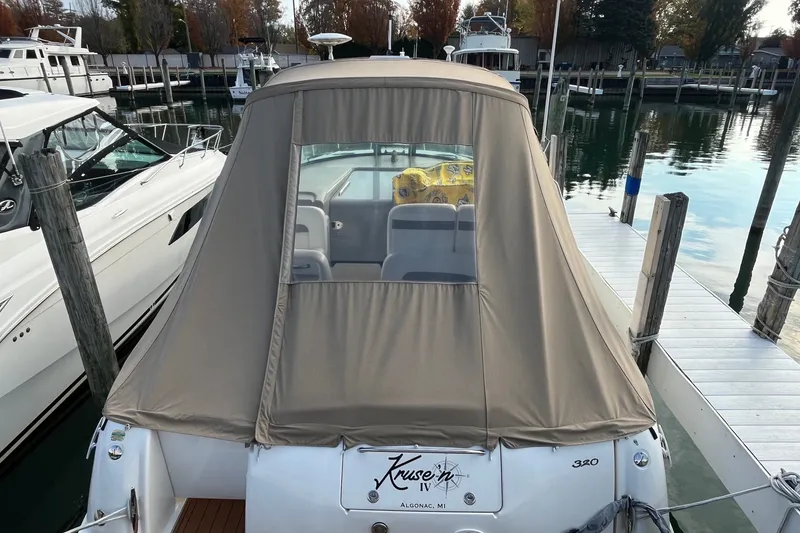 Slide: The Image of 2005 Sea Ray Sundancer 320 docked with beige canvas cover, rear view. - 3