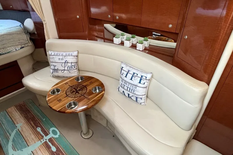 Slide: The Image of Interior of 2005 Sea Ray Sundancer 320 with cozy seating and nautical decor. - 24