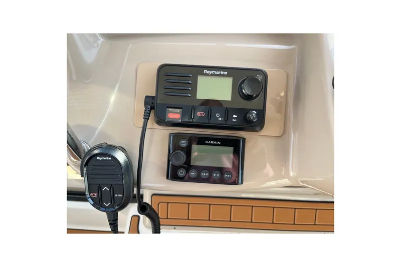 Slide: The Image of Control panel of a 2005 Sea Ray Sundancer 320 with Raymarine and Garmin devices. - 14