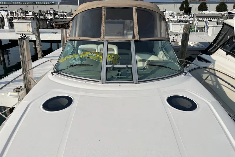 Slide: The Image of 2005 Sea Ray Sundancer 320 docked at marina, front view with windshield and deck. - 6