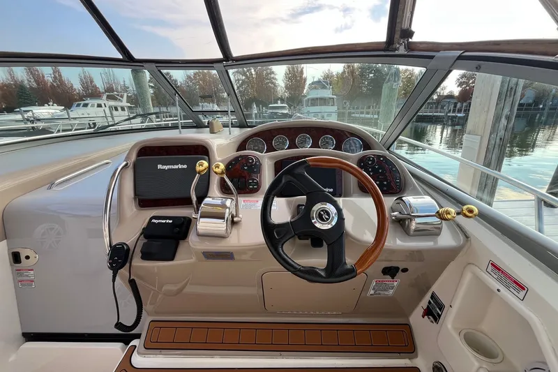 Slide: The Image of Cockpit of 2005 Sea Ray Sundancer 320 with steering wheel and navigation controls. - 10