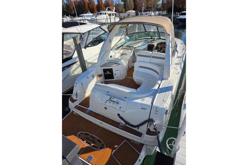 Slide: The Image of 2005 Sea Ray Sundancer 320 yacht with spacious deck and luxurious seating at marina. - 7