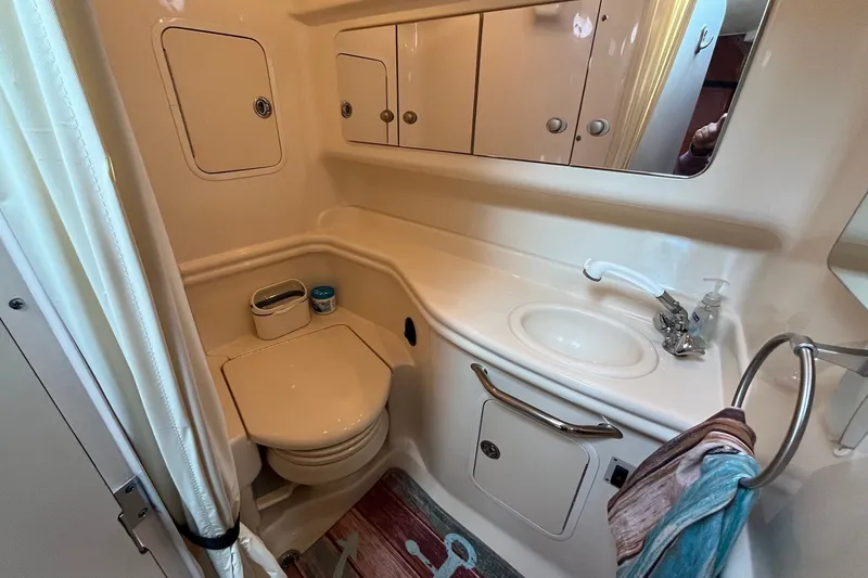 Slide: The Image of 2005 Sea Ray Sundancer 320 bathroom with sink, toilet, and storage cabinets. - 29