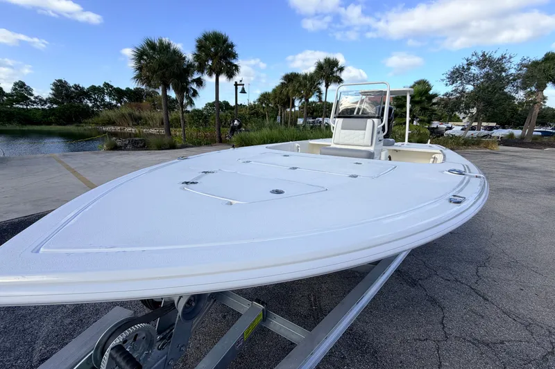 Slide: The Image of 2026 Mako 18 Pro Skiff boat on trailer, parked near a scenic waterfront. - 19