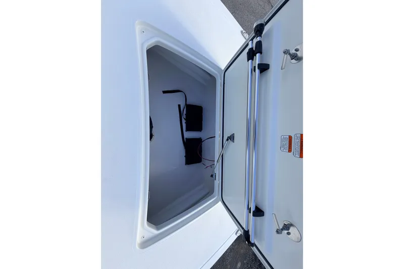 Slide: The Image of Open storage compartment of 2026 Mako 18 Pro Skiff boat, showing interior details. - 13
