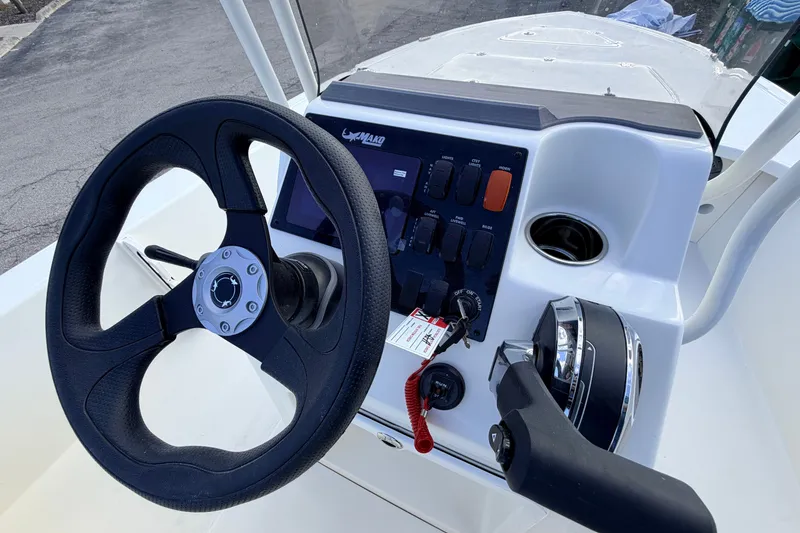 Slide: The Image of Steering console of 2026 Mako 18 Pro Skiff with controls and steering wheel. - 8