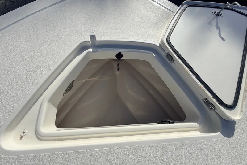 Slide: The Image of Open storage compartment on a 2026 Mako 18 Pro Skiff boat. - 14