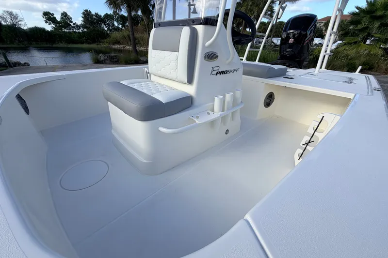 Slide: The Image of 2026 Mako 18 Pro Skiff boat interior with seating and rod holders. - 17
