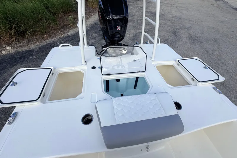 Slide: The Image of 2026 Mako 18 Pro Skiff boat deck with storage compartments and motor. - 7