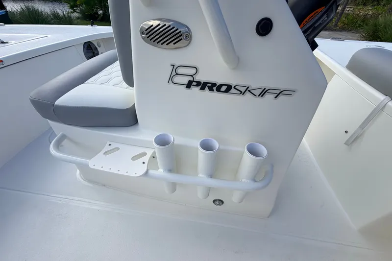 Slide: The Image of 2026 Mako 18 Pro Skiff boat interior with rod holders and seating. - 10