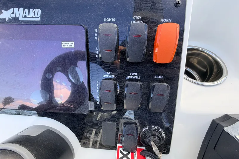 Slide: The Image of Control panel of a 2026 Mako 18 Pro Skiff boat with switches and key ignition. - 9