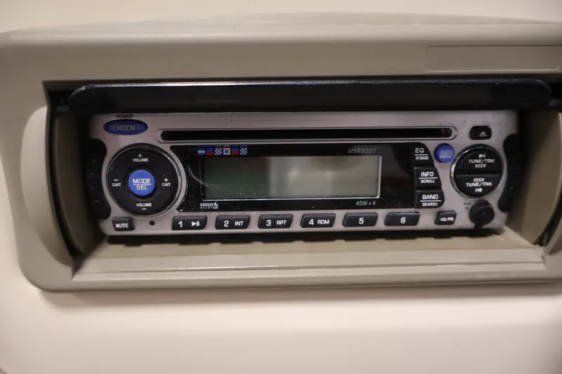 Slide: The Image of Jensen stereo system on 2008 Sun Tracker Fishin' Barge 21 boat dashboard. - 22