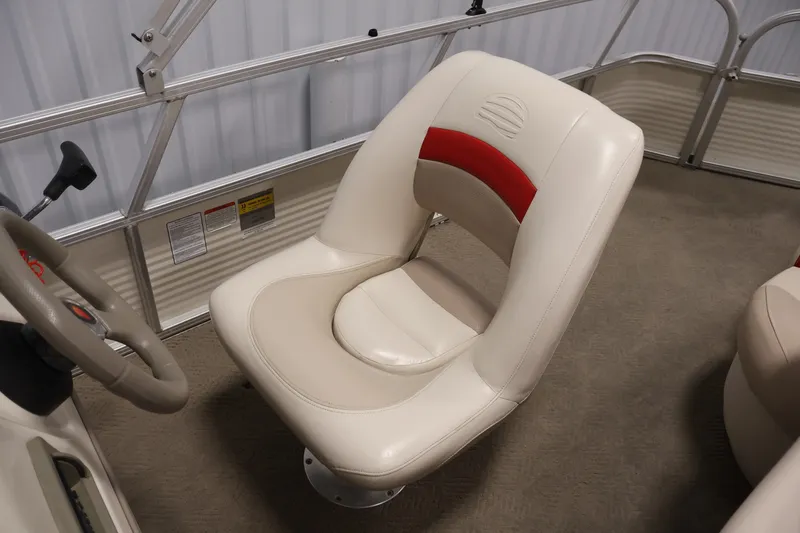 Slide: The Image of 2008 Sun Tracker Fishin' Barge 21 interior with beige and red captain's chair. - 23
