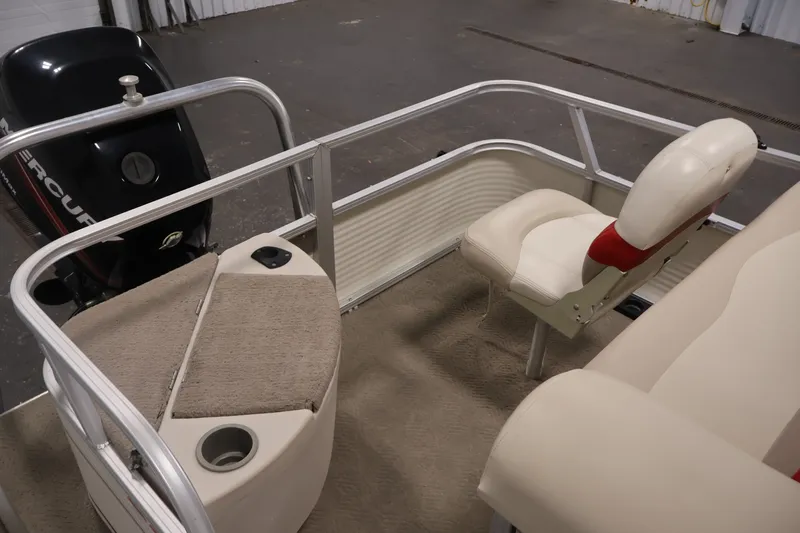 Slide: The Image of 2008 Sun Tracker Fishin' Barge 21 interior with seating and Mercury outboard motor. - 30