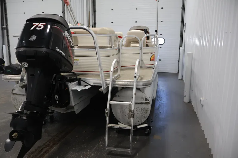 Slide: The Image of 2008 Sun Tracker Fishin' Barge 21 pontoon boat with Mercury 75 outboard motor in storage. - 36