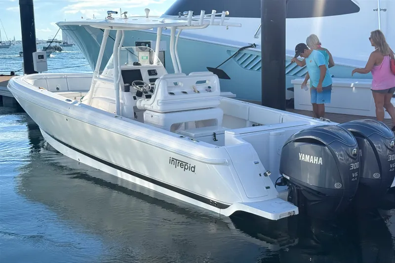 Slide: The Image of 2015 Intrepid 327 Center Console boat with twin Yamaha engines docked at marina. - 17
