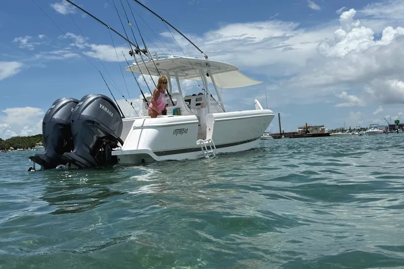 Slide: The Image of 2015 Intrepid 327 Center Console boat with Yamaha engines on clear water. - 3