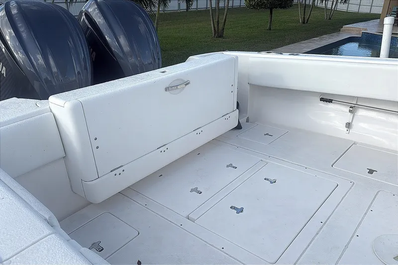 Slide: The Image of 2015 Intrepid 327 Center Console boat interior with Yamaha engines, featuring spacious deck layout. - 14