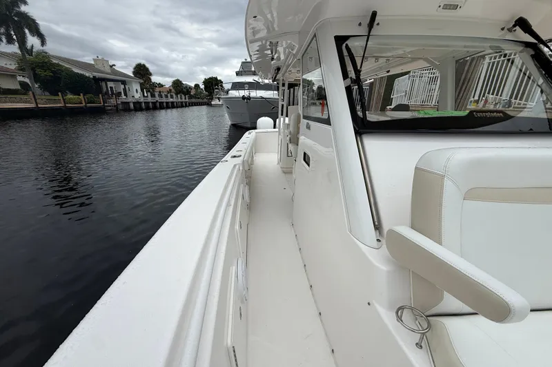 Slide: The Image of 2016 Everglades 435 Center Console boat docked on a calm canal. - 18