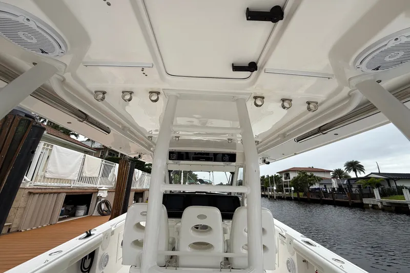 Slide: The Image of 2016 Everglades 435 Center Console boat interior with seating and overhead view. - 24