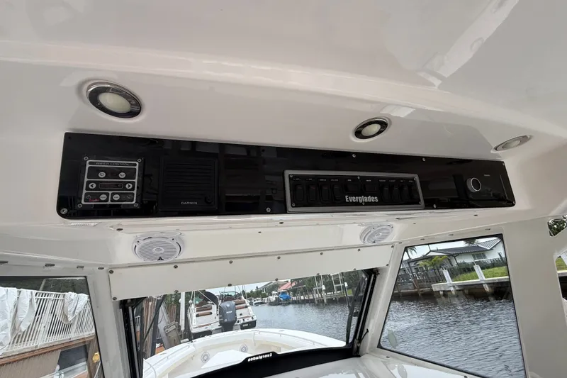 Slide: The Image of Interior view of 2016 Everglades 435 Center Console boat with control panel and speakers. - 33