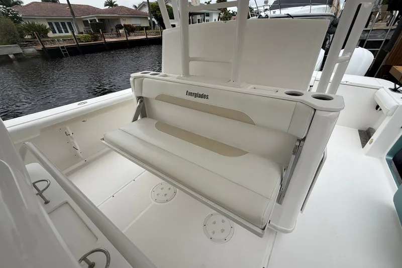Slide: The Image of 2016 Everglades 435 Center Console boat interior with foldable seating by the water. - 20