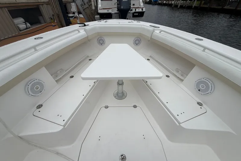 Slide: The Image of 2016 Everglades 435 Center Console boat interior with seating and table. - 15