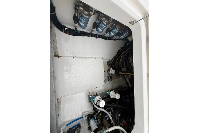 Slide: The Image of Engine compartment of a 2016 Everglades 435 Center Console boat, showing filters and hoses. - 23