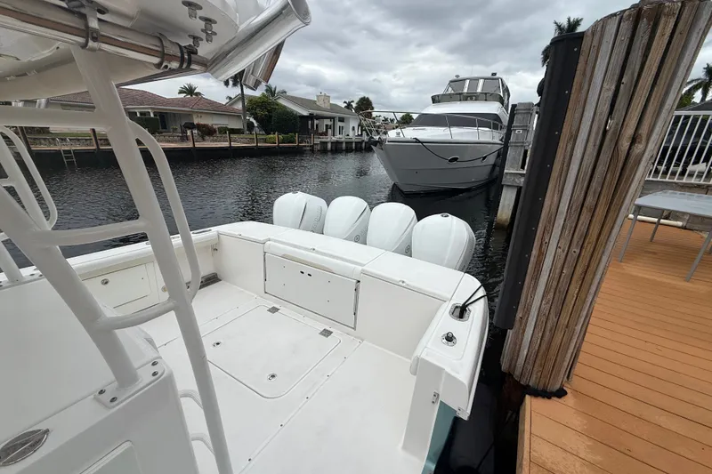 Slide: The Image of 2016 Everglades 435 Center Console docked, featuring four powerful outboard engines. - 27