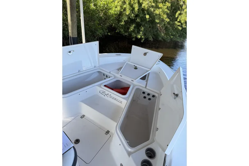 Slide: The Image of 2015 Crevalle 24 Bay boat with open storage compartments on deck. - 52