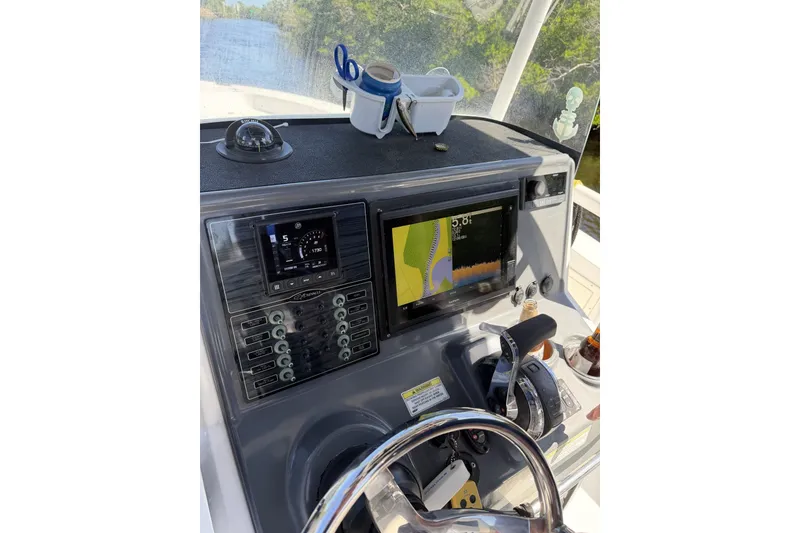 Slide: The Image of Control panel of a 2015 Crevalle 24 Bay boat with navigation screens. - 22