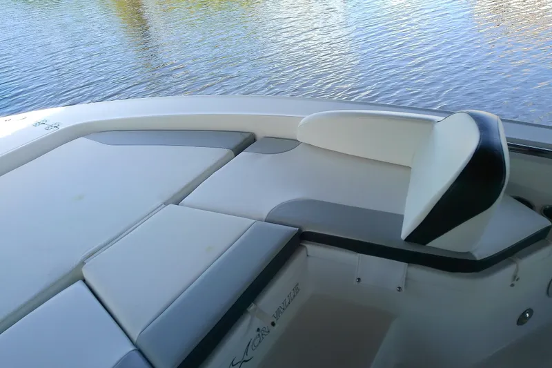 Slide: The Image of 2015 Crevalle 24 Bay boat interior with cushioned seating by the water. - 30