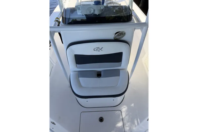 Slide: The Image of 2015 Crevalle 24 Bay boat seat with logo, featuring white and navy upholstery. - 46