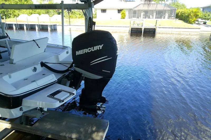 Slide: The Image of 2015 Crevalle 24 Bay boat with Mercury outboard motor docked by waterfront. - 7