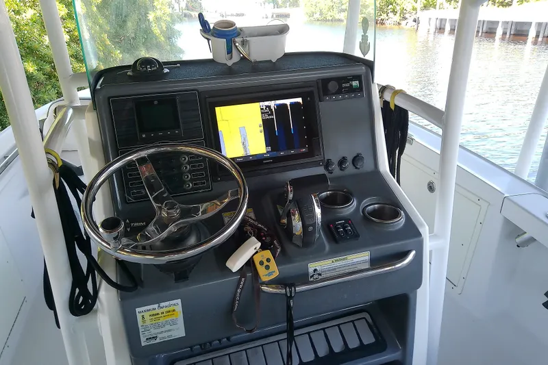 Slide: The Image of 2015 Crevalle 24 Bay boat dashboard with steering wheel and navigation system. - 21