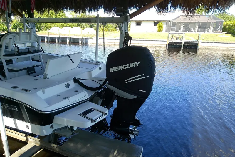 Slide: The Image of 2015 Crevalle 24 Bay boat with Mercury Verado engine docked by waterfront. - 6