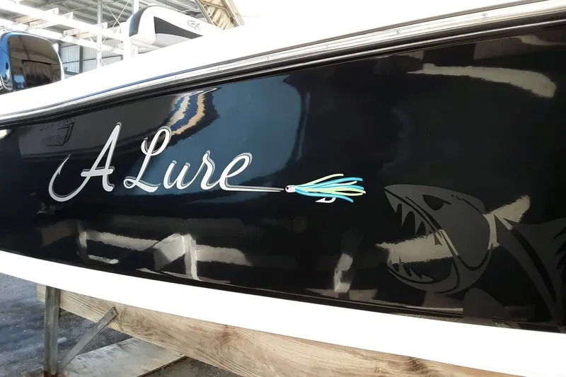 Slide: The Image of 2015 Crevalle 24 Bay boat with "A Lure" decal and shark graphic. - 42