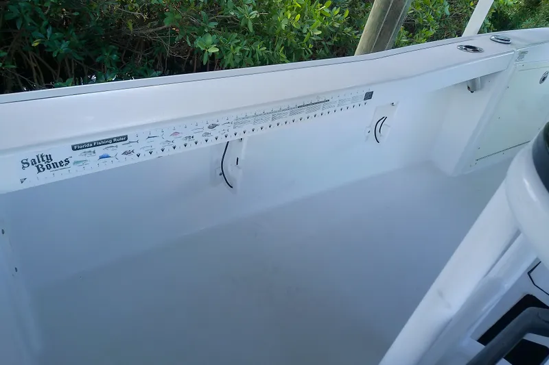 Slide: The Image of 2015 Crevalle 24 Bay boat interior with Florida fishing ruler and Salty Bones branding. - 36